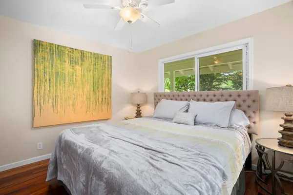 a bedroom with a large bed and a chandelier