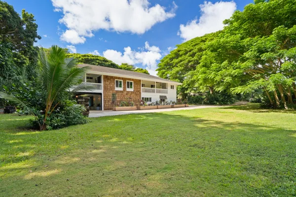 a front view of house with yard and green space