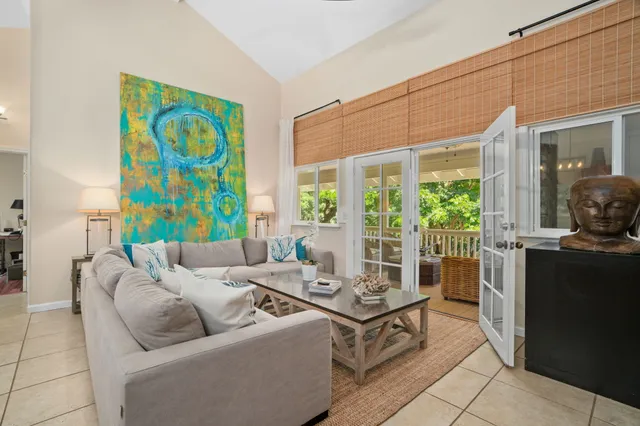 a kitchen with stainless steel appliances granite countertop a sink a stove a refrigerator and chairs