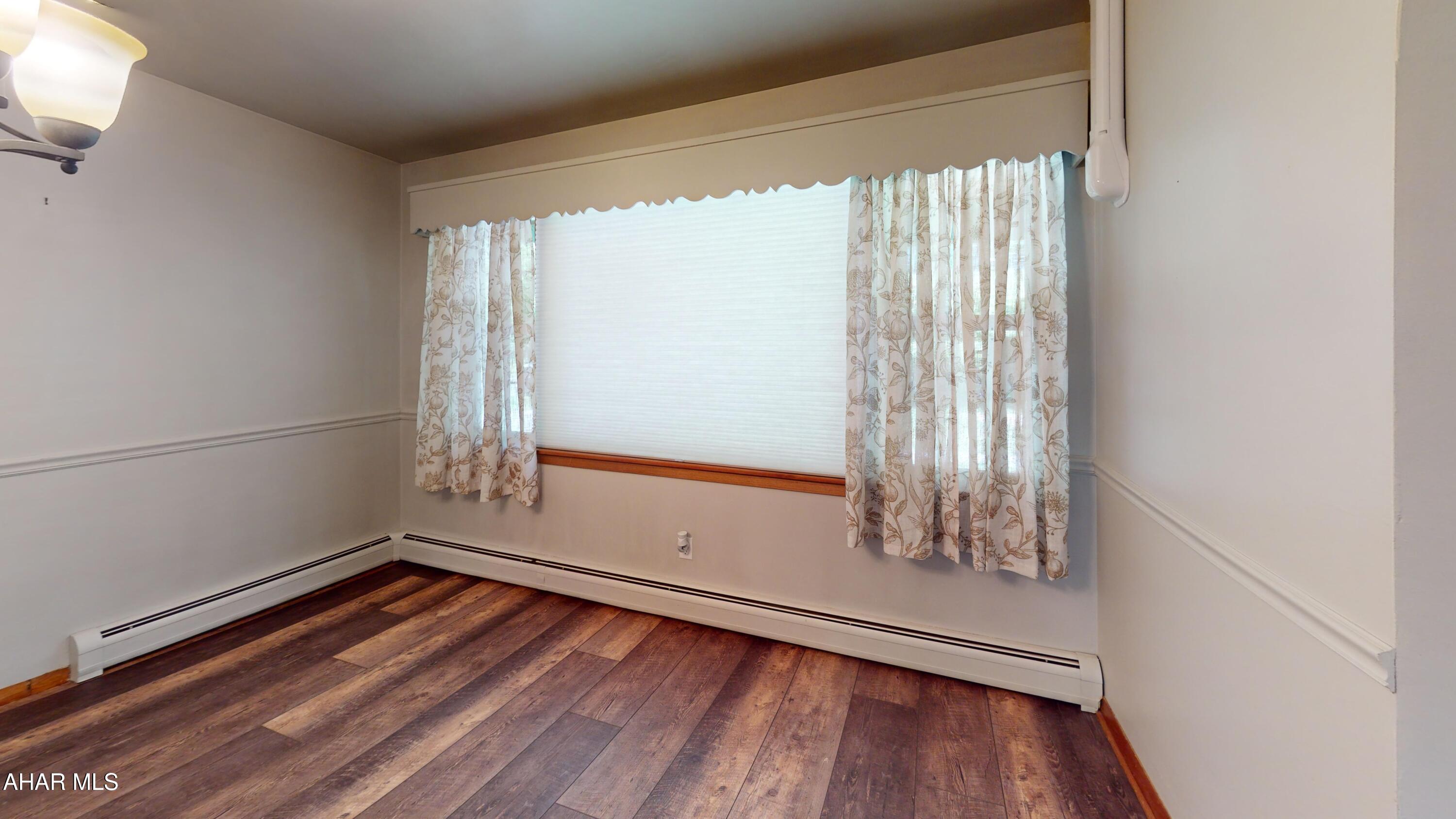 871 Decker Hollow Road Tyrone, PA 16686 - Photo 29 of 35 an empty room with wooden floor and windows