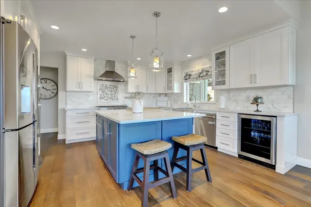 a kitchen with stainless steel appliances granite countertop a stove and a refrigerator
