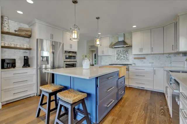 a stove top oven sitting inside of a kitchen