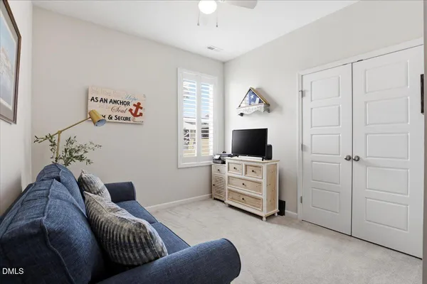 a bedroom with a bed next to a window