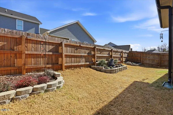 a view of a house with wooden floor and a iron fence