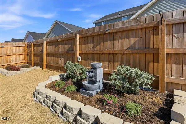 a view of a house with wooden fence