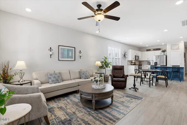 a living room with furniture and a potted plant