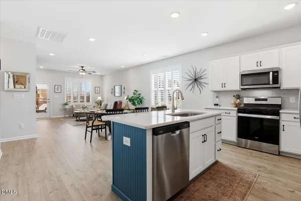 a living room with furniture a fireplace and a potted plant