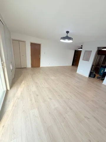 a view of empty room with floor to ceiling window