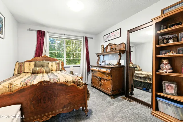 a bedroom with a bed and dresser