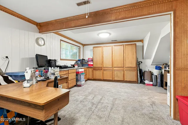 a kitchen with sink cabinets and living room view