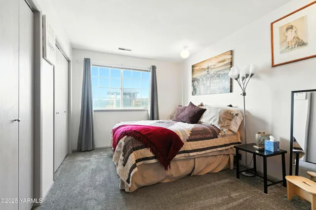 a spacious bedroom with a bed and window