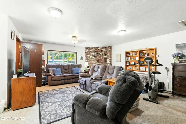 a living room with furniture large window and a flat screen tv