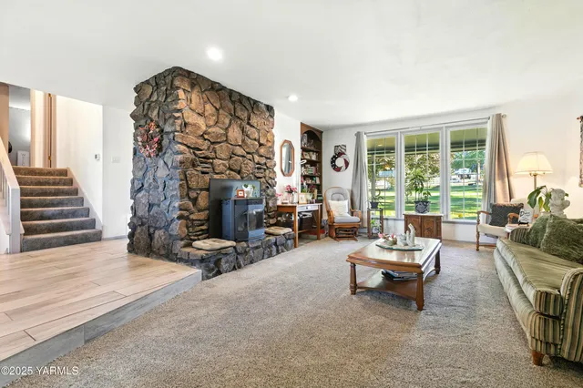 a living room with furniture and a fireplace