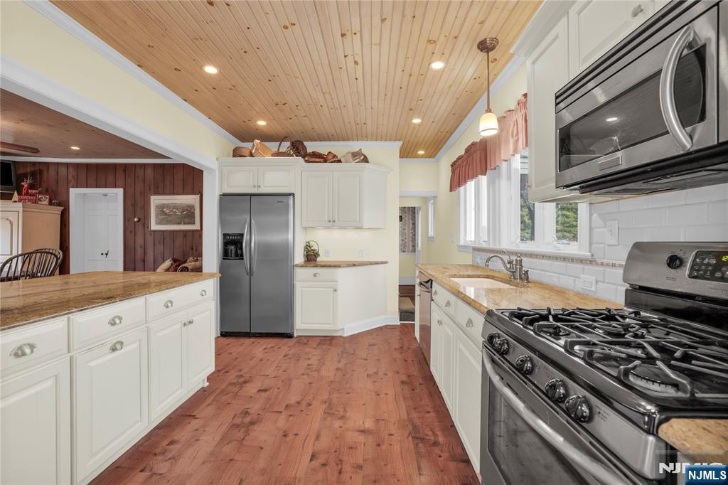 265 Little Falls Road Cedar Grove, NJ 07009 - Photo 20 of 44 a large kitchen with stainless steel appliances granite countertop a stove and a refrigerator