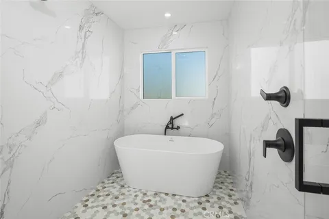 a bedroom with a bed and a potted plant