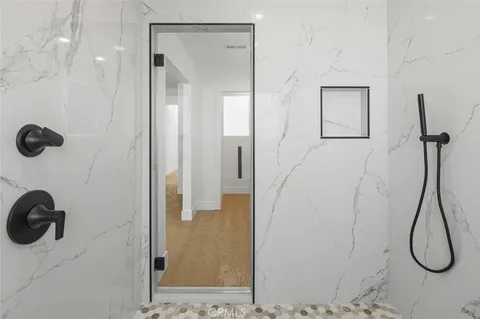 a bedroom with a bed and a potted plant