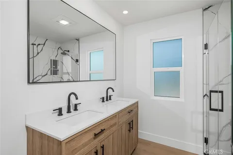 a bathroom with a sink a toilet and mirror