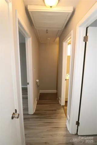 a view of a hallway with wooden floor and staircase