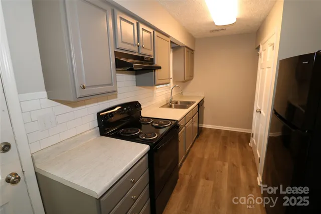 a kitchen with a stove and a refrigerator
