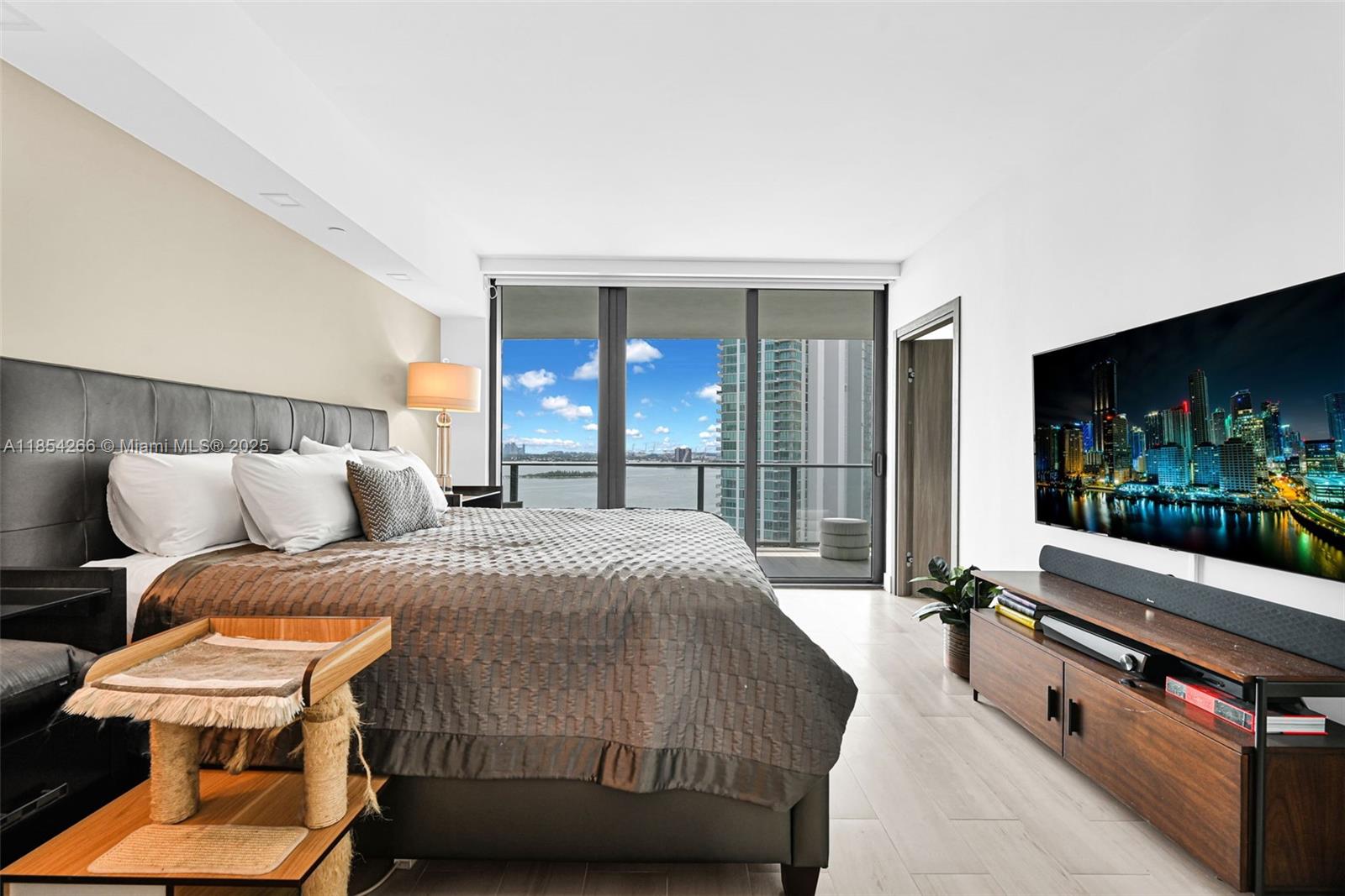 650 Northeast 32nd Street, Unit 2201 Miami, FL 33137 - Photo 15 of 35 a bed room with a bed and a television