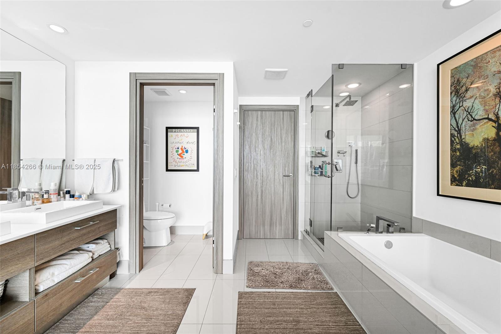 650 Northeast 32nd Street, Unit 2201 Miami, FL 33137 - Photo 17 of 35 a bathroom with a tub a toilet a sink and shower