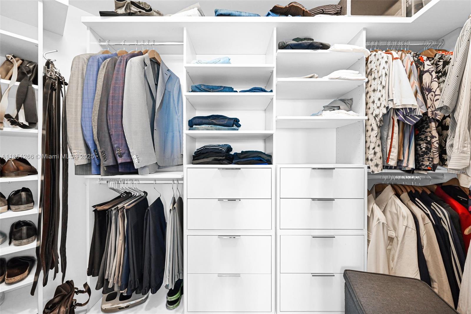 650 Northeast 32nd Street, Unit 2201 Miami, FL 33137 - Photo 19 of 35 a view of walk in closet with clothes and shoes