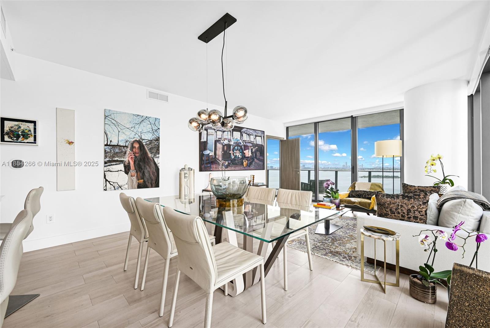 650 Northeast 32nd Street, Unit 2201 Miami, FL 33137 - Photo 6 of 35 a living room with furniture and a chandelier