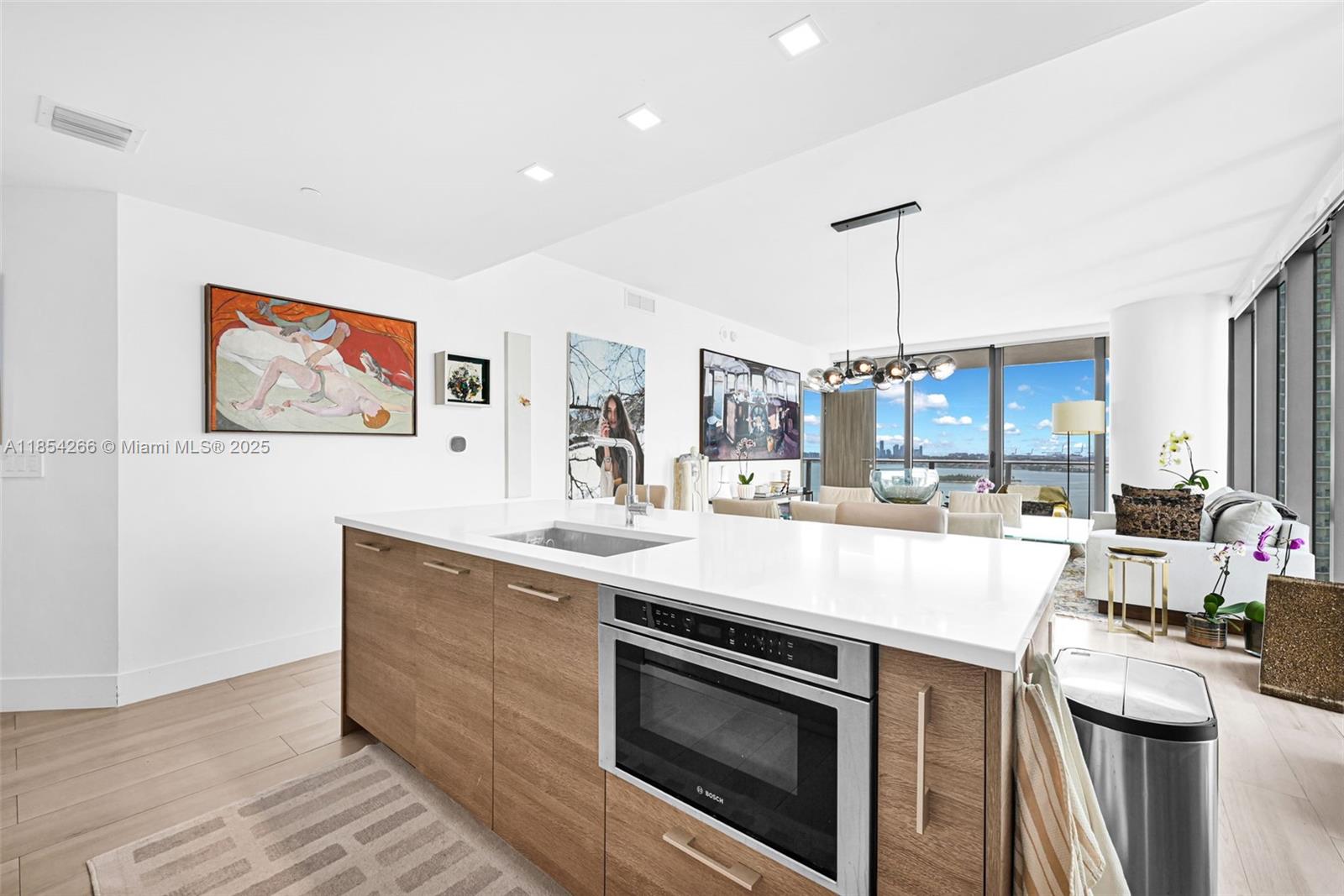 650 Northeast 32nd Street, Unit 2201 Miami, FL 33137 - Photo 7 of 35 a open kitchen with stainless steel appliances granite countertop a stove and a sink with cabinets