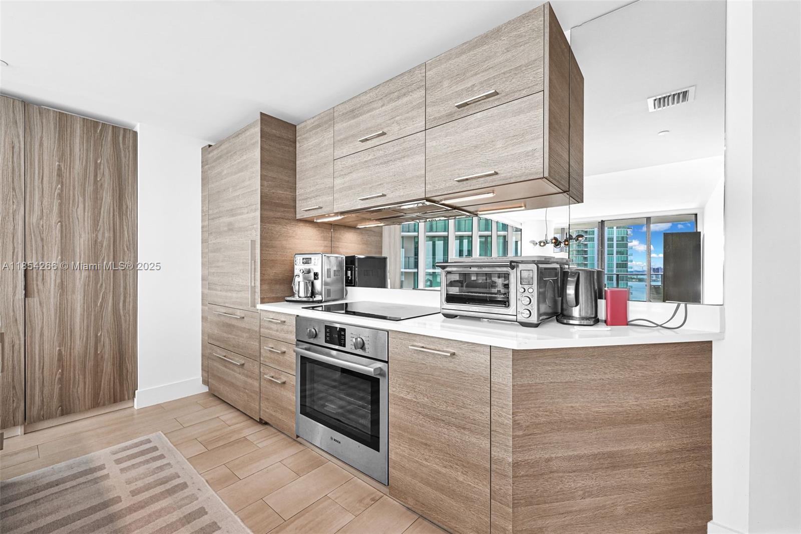 650 Northeast 32nd Street, Unit 2201 Miami, FL 33137 - Photo 8 of 35 a kitchen with granite countertop a sink and a stove