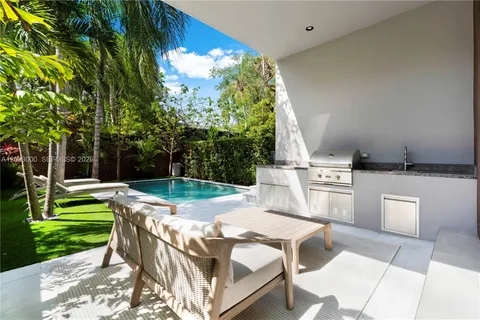 a view of an house with backyard porch and sitting area
