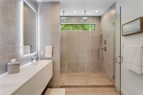 a bathroom with a shower and a sink