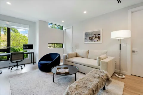 a living room with furniture and a lamp