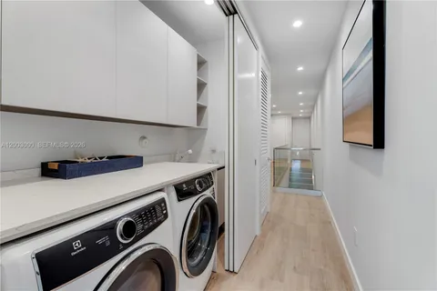 a view of a kitchen with washer and dryer