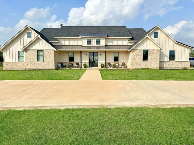 a front view of house with yard and outdoor seating