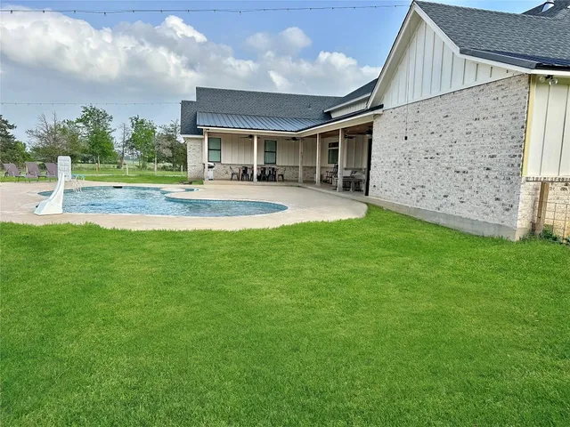 a front view of house with a garden