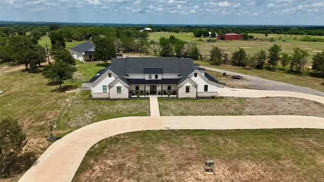 an aerial view of a house with outdoor space