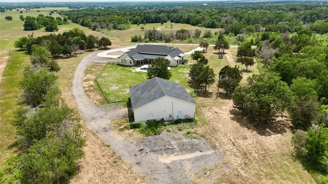 an aerial view of house with yard swimming pool and outdoor seating