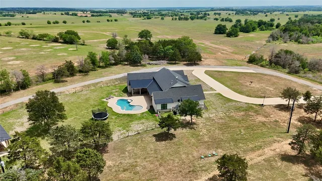 an aerial view of a house with a yard lake view and mountain view