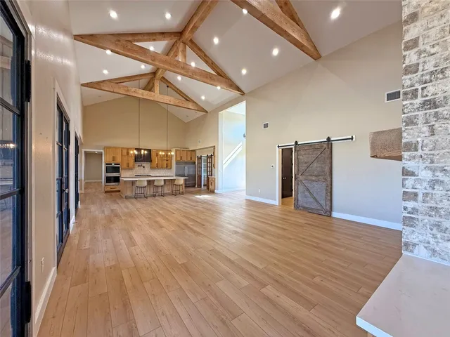 a large white kitchen with wooden floors and lots of counter space