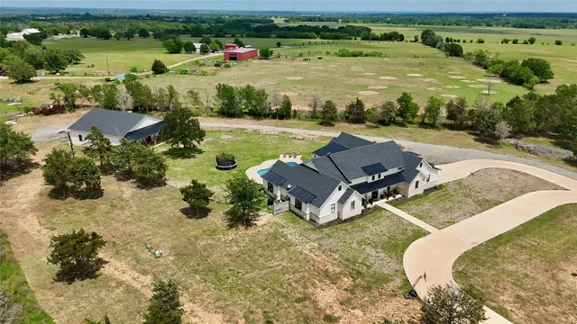 an aerial view of a house with a yard