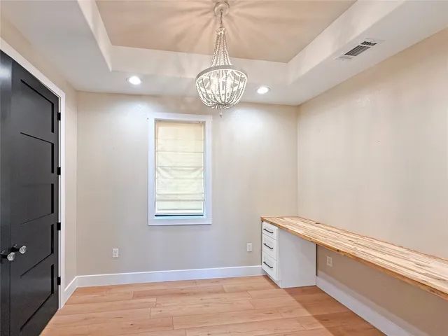 a view of a kitchen with a refrigerator and a stove
