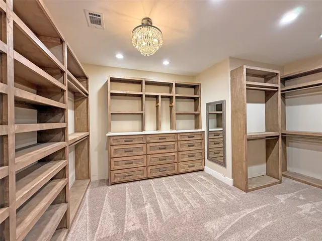 an empty room with windows and a ceiling fan