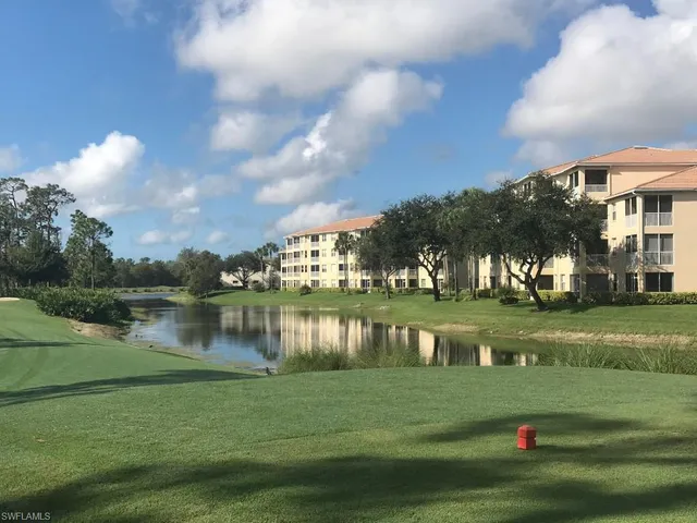 a view of building with river in front of it