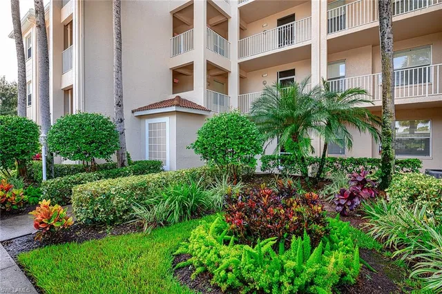 front view of a multi story building with a yard