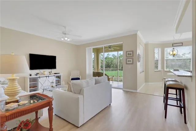 a living room with furniture floor and a flat screen tv