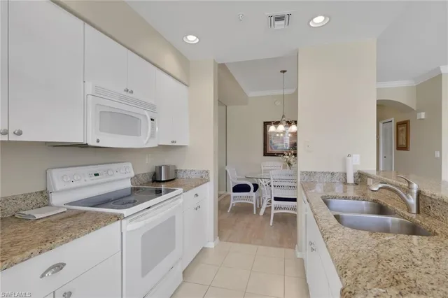 a kitchen with stainless steel appliances granite countertop a sink and cabinets