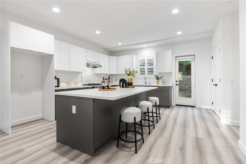 1359 Point Loma Place Walnut, CA 91789 - Photo 22 of 75 a kitchen with stainless steel appliances granite countertop a refrigerator a sink dishwasher a stove and white countertops with wooden floor