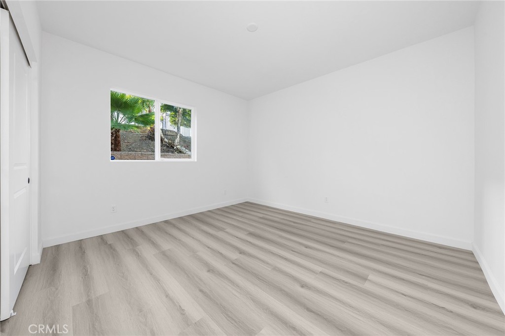 1359 Point Loma Place Walnut, CA 91789 - Photo 30 of 75 an empty room with wooden floor and windows