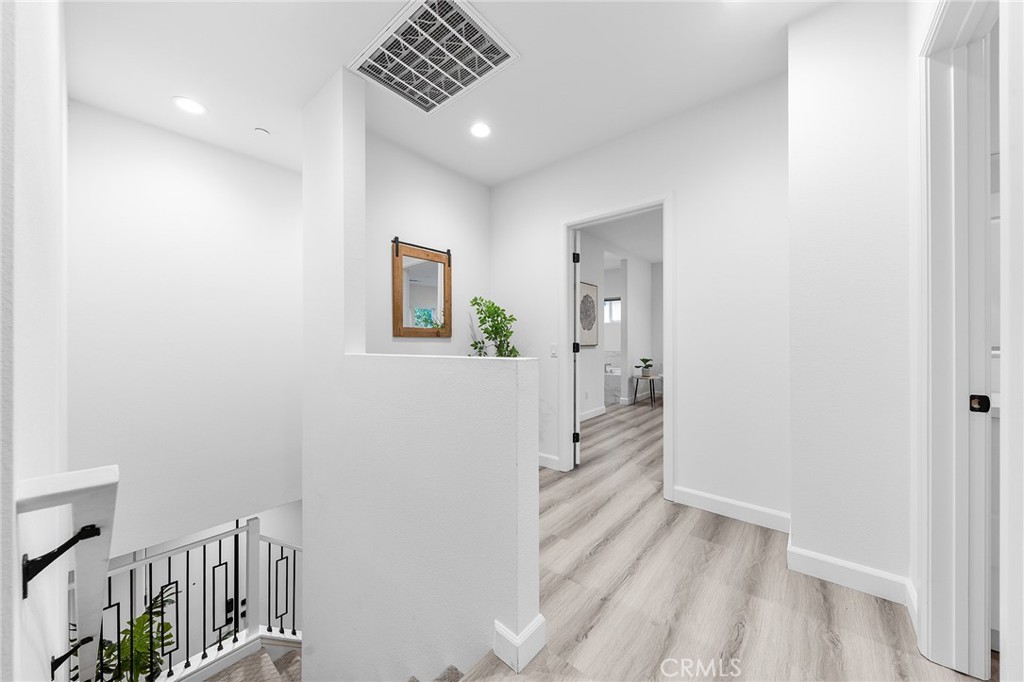 1359 Point Loma Place Walnut, CA 91789 - Photo 35 of 75 a view of a hallway with wooden floor and a bathroom