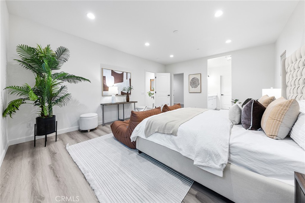 1359 Point Loma Place Walnut, CA 91789 - Photo 43 of 75 a bedroom with a large bed and a potted plant